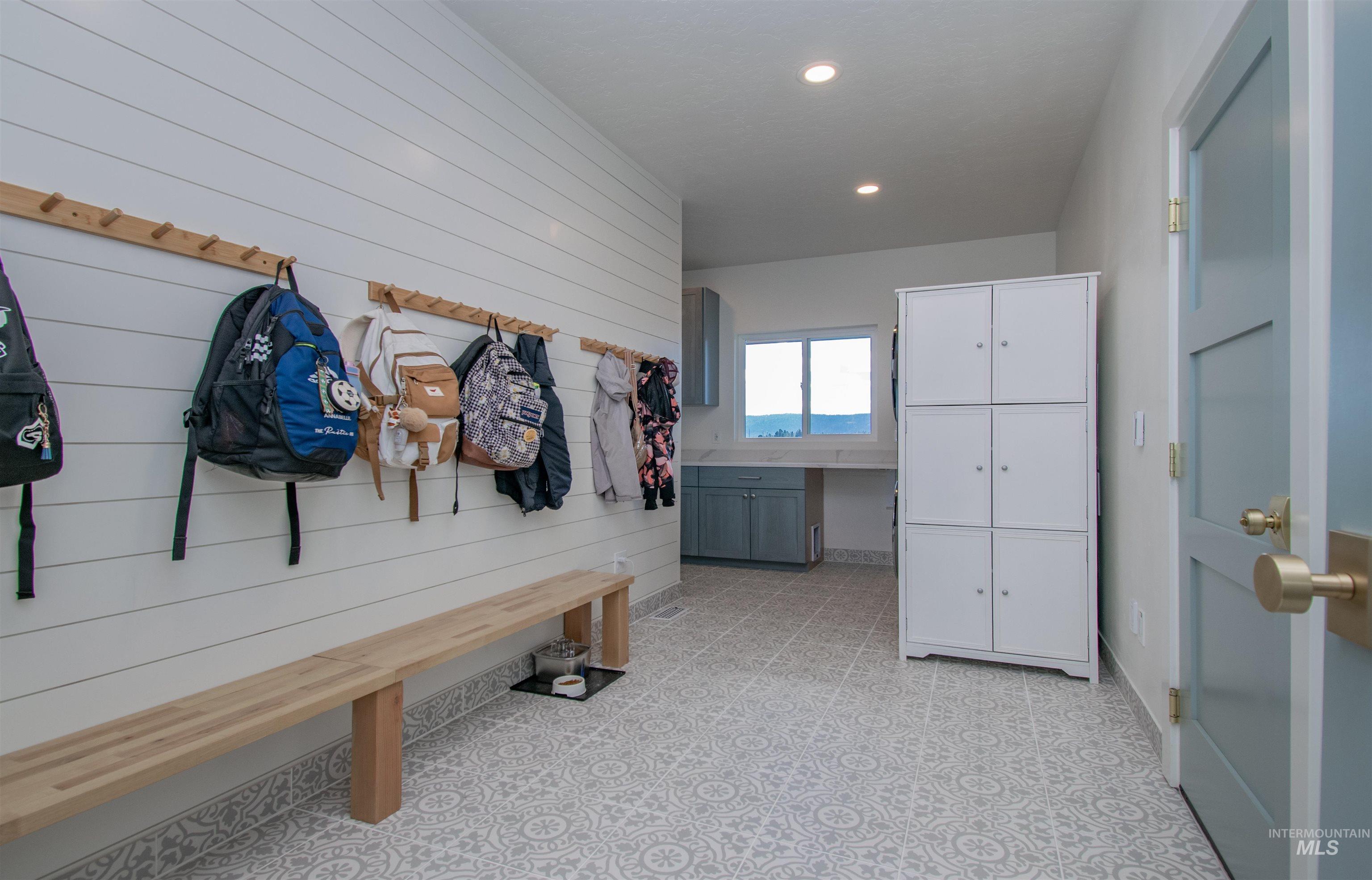 44 Big Moose Road McCall, ID 83638 - Photo 37 of 50 Entryway featuring shiplap wall paneling, a built-in wooden bench, and a peg rail system