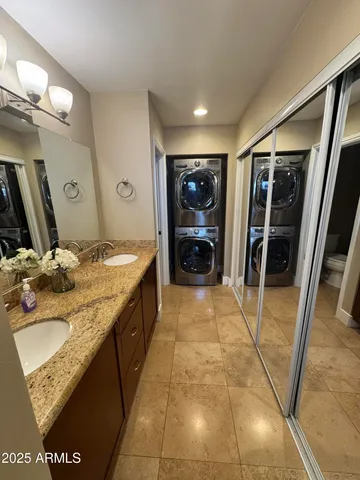 a bathroom with a granite countertop sink a toilet and mirror
