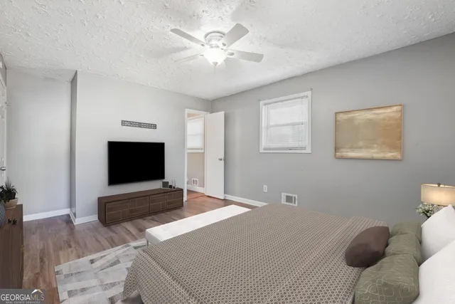 a bedroom with a bed and a flat screen tv