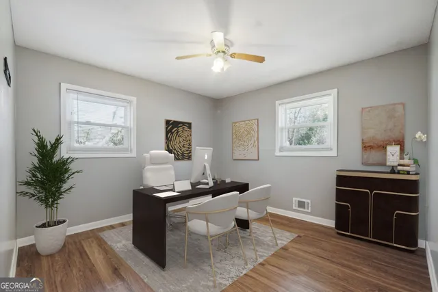 a living room with furniture and a potted plant