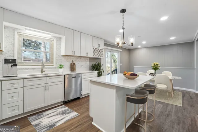 a kitchen that has a lot of cabinets in it