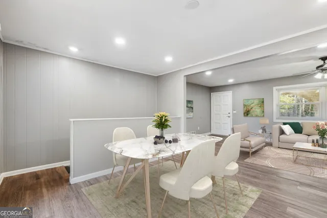 a view of a dining room with furniture window and wooden floor