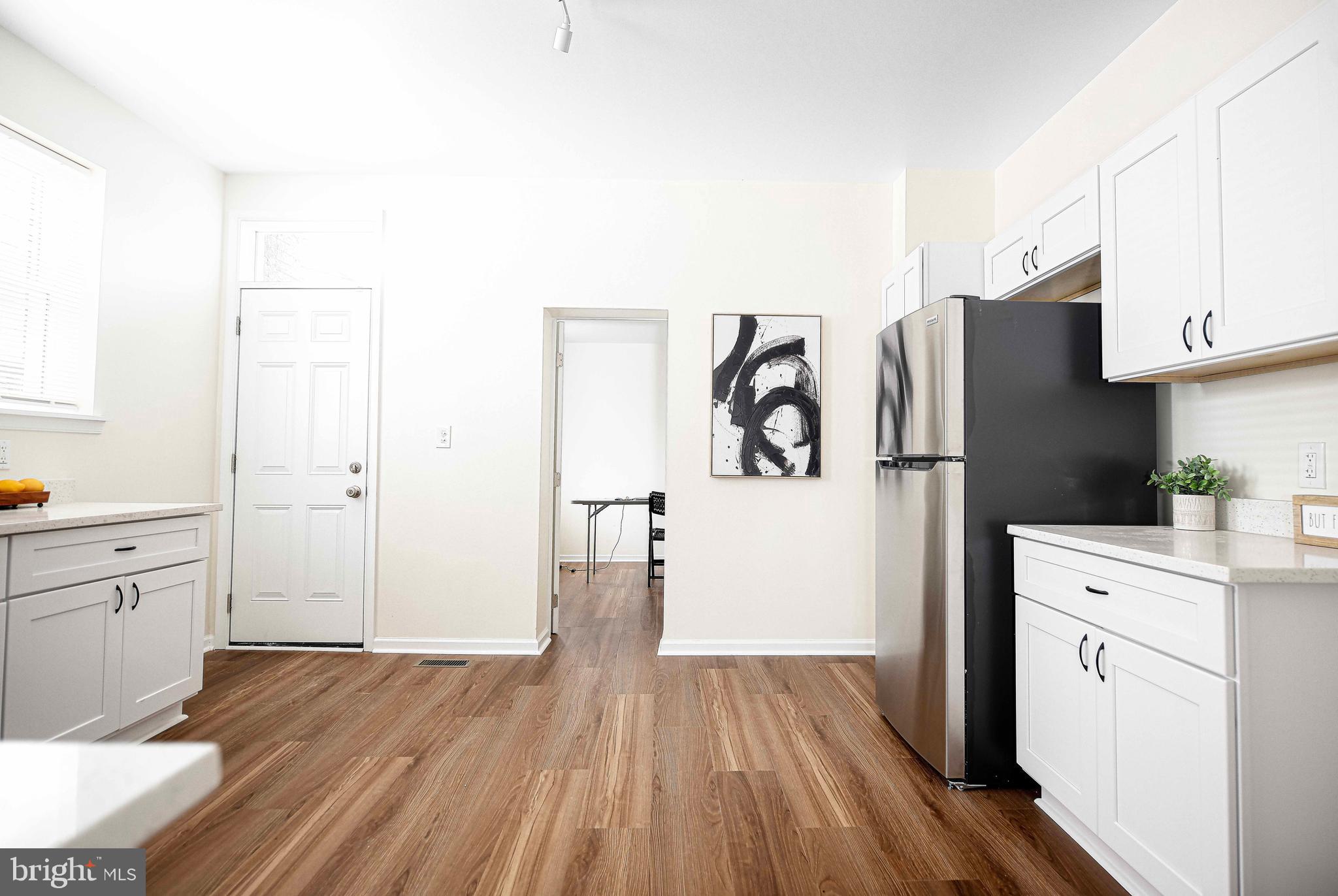535 North Decker Avenue Baltimore, MD 21205 - Photo 12 of 24 a kitchen with white cabinets and refrigerator