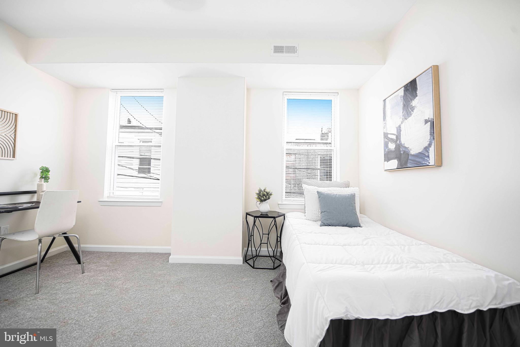 535 North Decker Avenue Baltimore, MD 21205 - Photo 16 of 24 a bedroom with a bed a table and chair