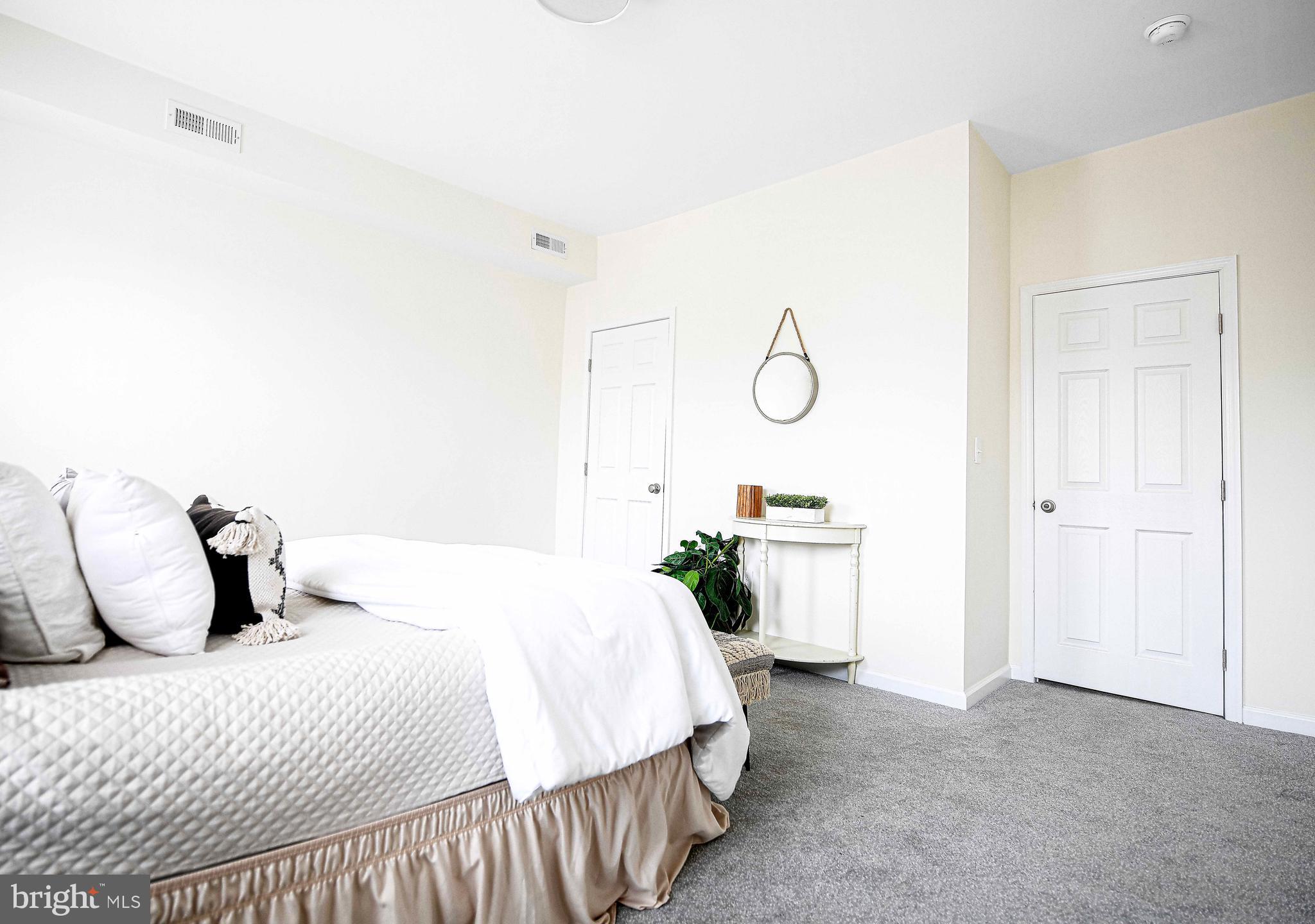 535 North Decker Avenue Baltimore, MD 21205 - Photo 18 of 24 a bedroom with a bed and painting on the wall