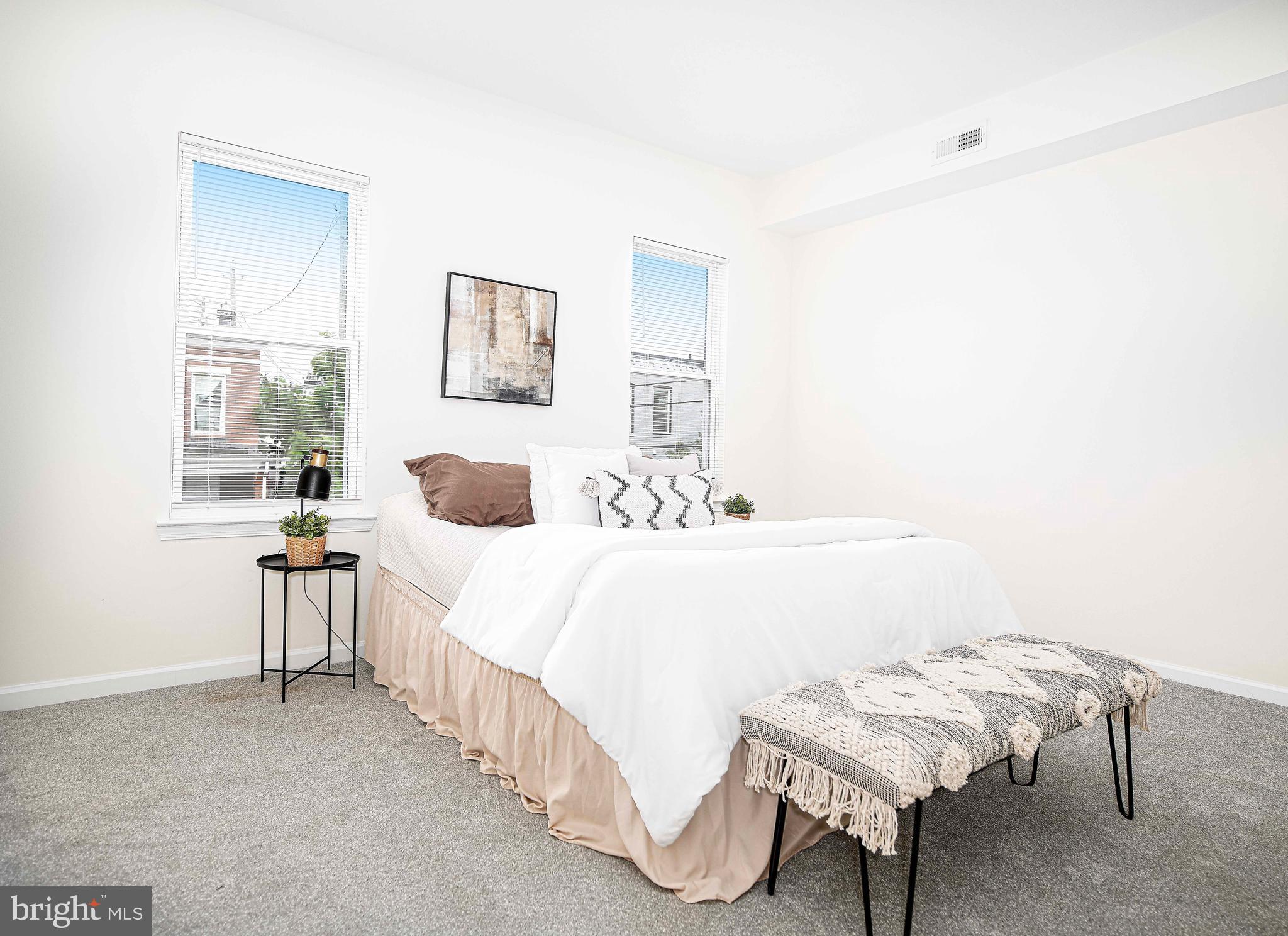 535 North Decker Avenue Baltimore, MD 21205 - Photo 19 of 24 a bedroom with a bed a table and chair