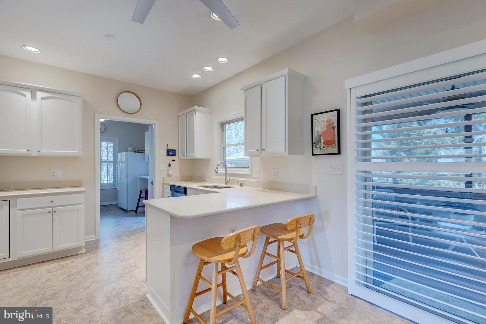 33006 Deer Trail Millville, DE 19967 - Photo 13 of 54 a kitchen with white cabinets and sink