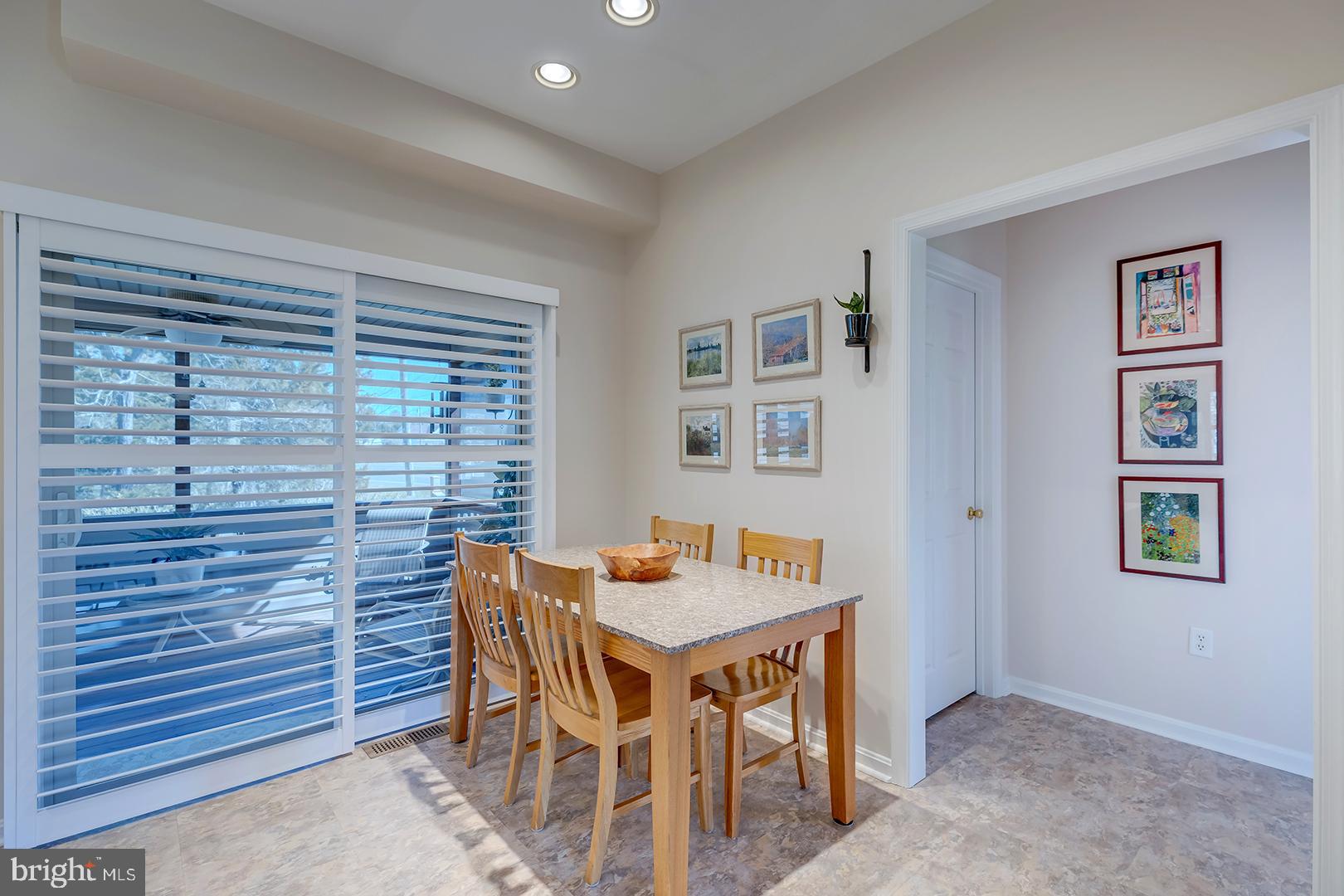33006 Deer Trail Millville, DE 19967 - Photo 14 of 54 a dining room with a table and chairs
