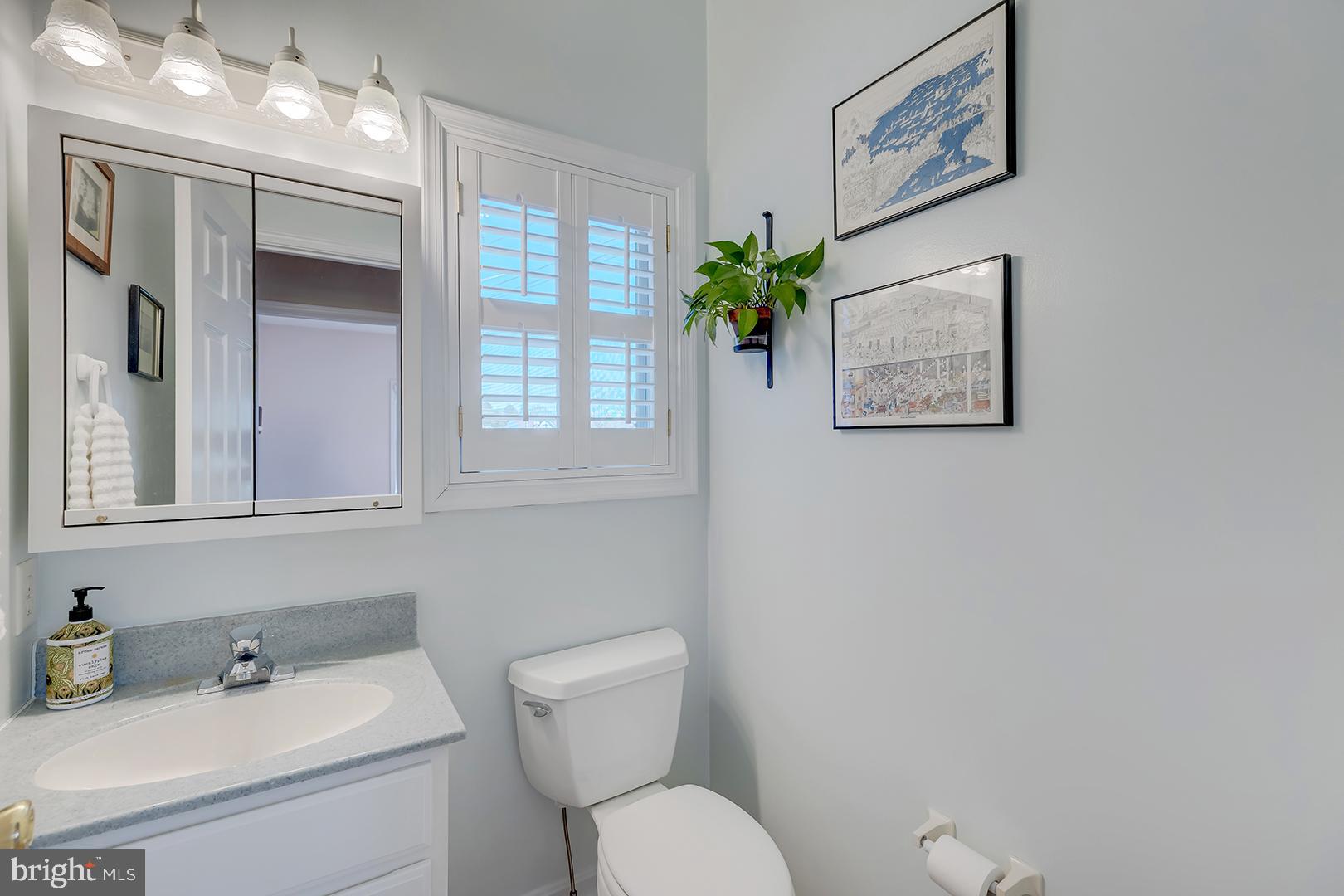 33006 Deer Trail Millville, DE 19967 - Photo 19 of 54 a bathroom with a toilet sink and mirror