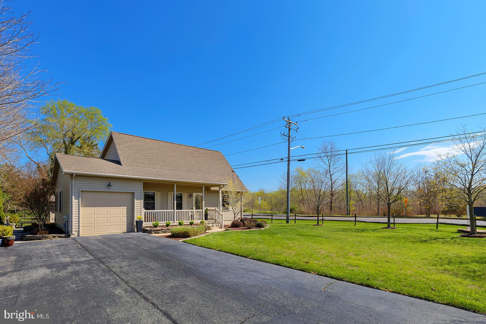 33006 Deer Trail Millville, DE 19967 - Photo 2 of 54 a view of a house with a big yard and palm trees