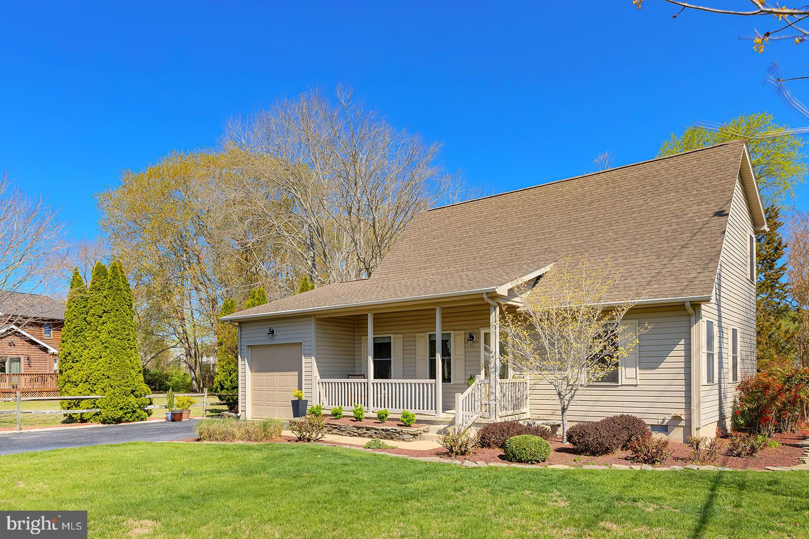33006 Deer Trail Millville, DE 19967 - Photo 3 of 54 a front view of a house with garden