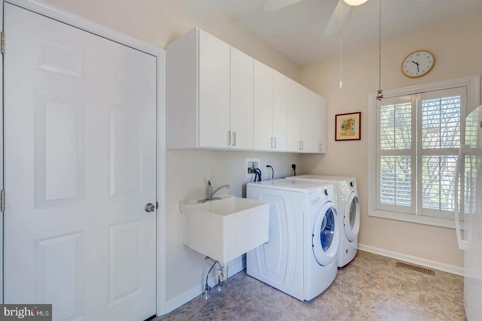33006 Deer Trail Millville, DE 19967 - Photo 32 of 54 a utility room with cabinets washer and a window