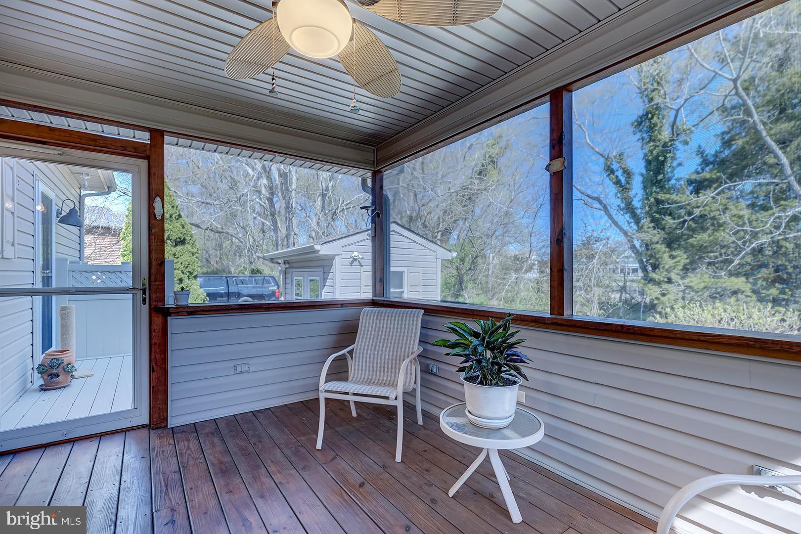 33006 Deer Trail Millville, DE 19967 - Photo 38 of 54 a porch with seating space and wooden floor
