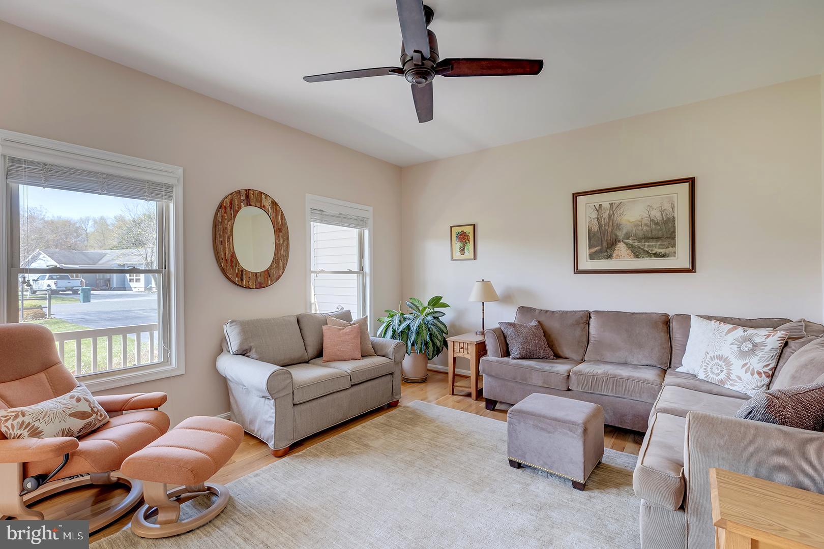 33006 Deer Trail Millville, DE 19967 - Photo 9 of 54 a living room with furniture a rug potted plant and a large window
