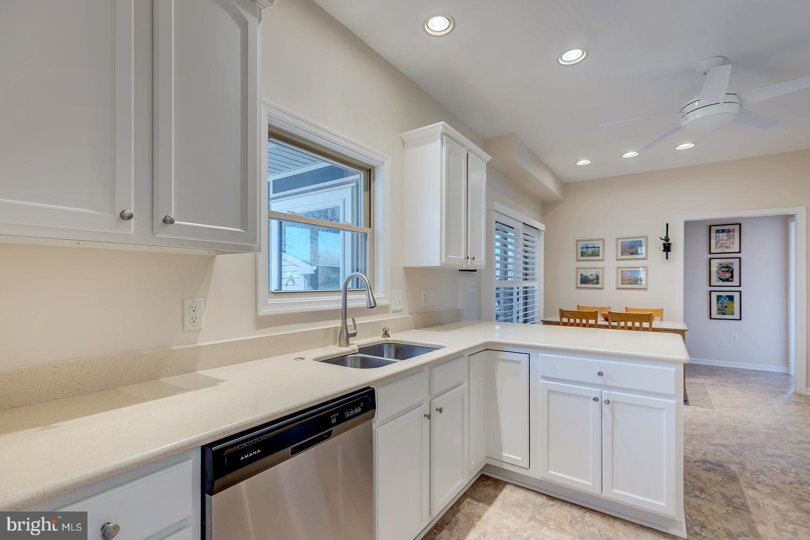 33006 Deer Trail Millville, DE 19967 - Photo 10 of 54 a kitchen with white cabinets and sink