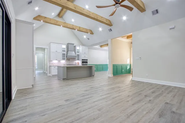 a kitchen with granite countertop a sink stainless steel appliances and cabinets