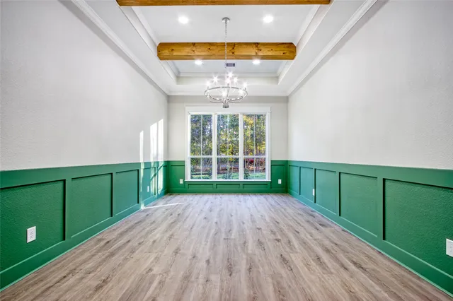 a view of a room with wooden floor and a ceiling fan