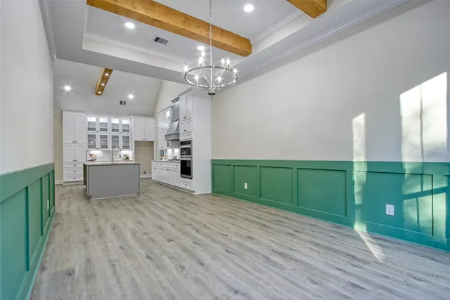 a view of a room with window wooden floor and front door