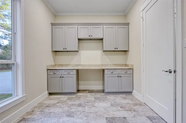 a kitchen with granite countertop a stove and cabinets