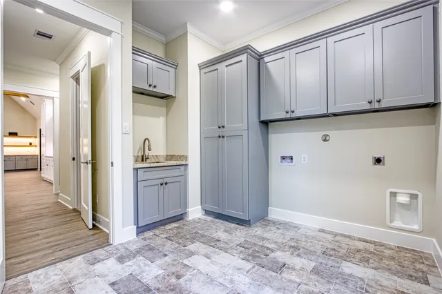 a view of a kitchen with white cabinets and wooden floor
