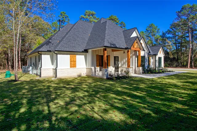 a front view of house with a garden