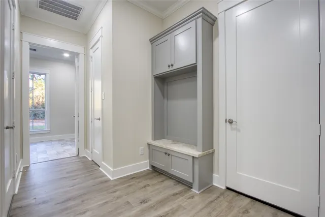 a view of an empty room with wooden floor