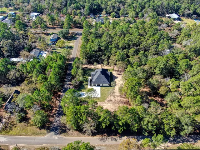 a aerial view of a house with a yard and garden