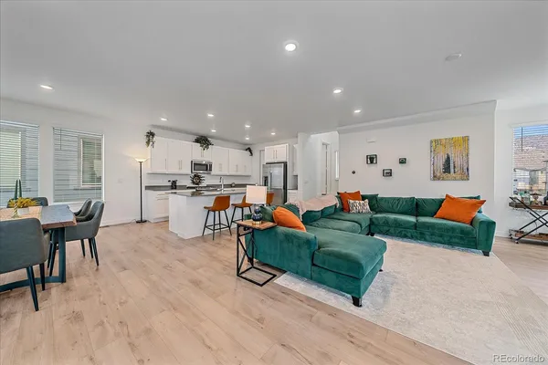 a living room with furniture and kitchen view