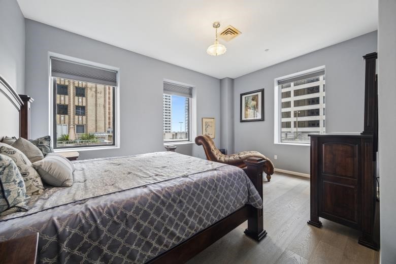 914 Main Street, Unit 1204 Houston, TX 77002 - Photo 9 of 34 Primary bedroom with large windows, lots of natural light, and skyline views.