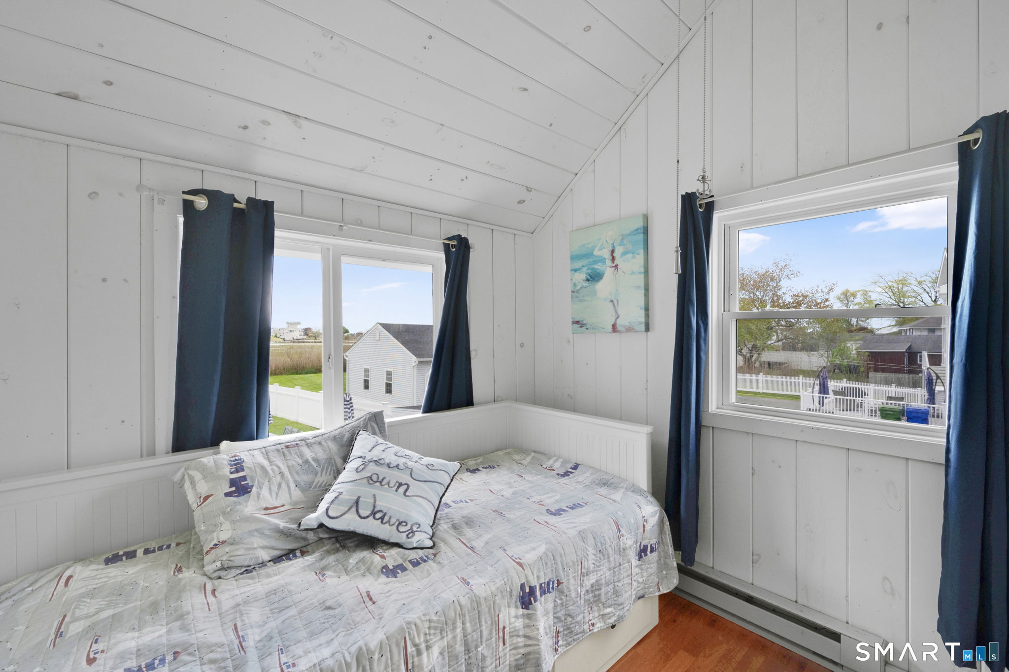 96 Chalker Beach Road Old Saybrook, CT 06475 - Photo 32 of 33 a bedroom with a large bed and a large window