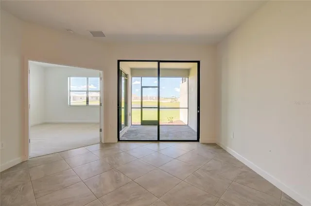 an empty room with windows and closet