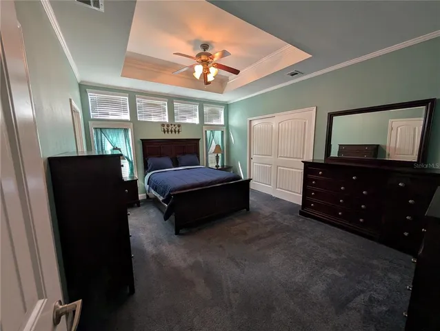 a bedroom with a bed window and dresser