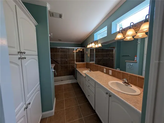 a bathroom with a double vanity sink and mirror