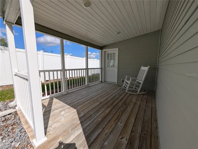 a view of balcony with wooden floor and outdoor seating