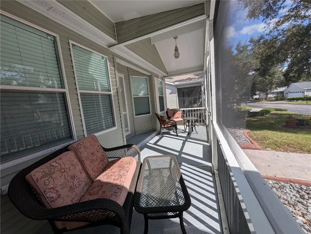 a view of a patio with couple of chairs and a table