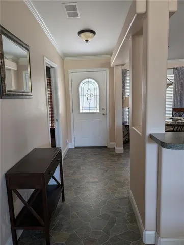 a view of a hallway with workspace and a window