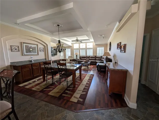 a living room with lots of furniture and wooden floor