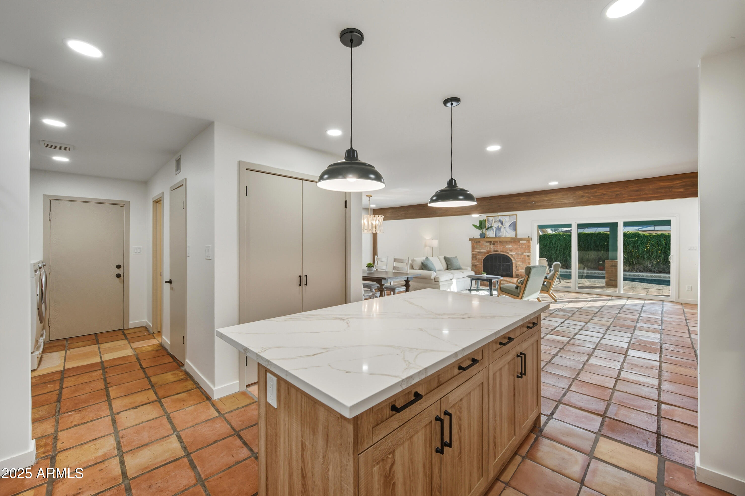 a large kitchen with kitchen island a stove a sink a window and a counter top space
