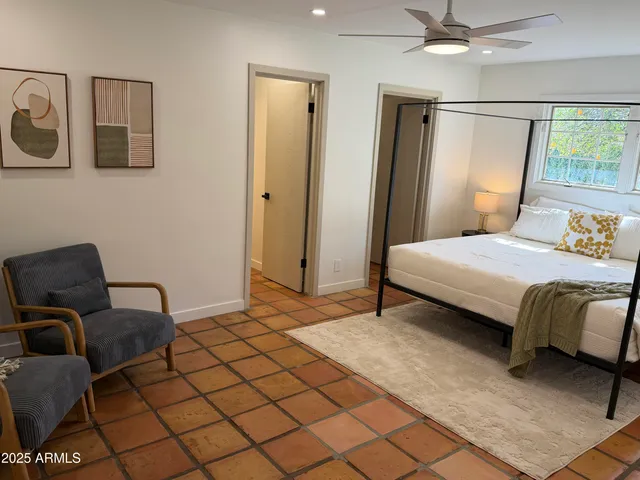 a living room with furniture a large window and a fireplace