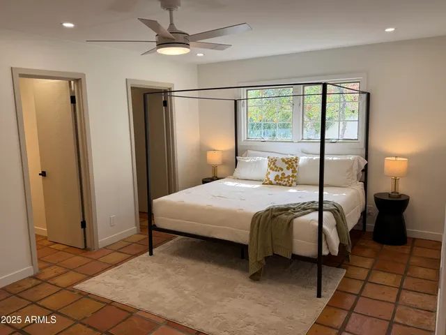 a bedroom with a bed and chair