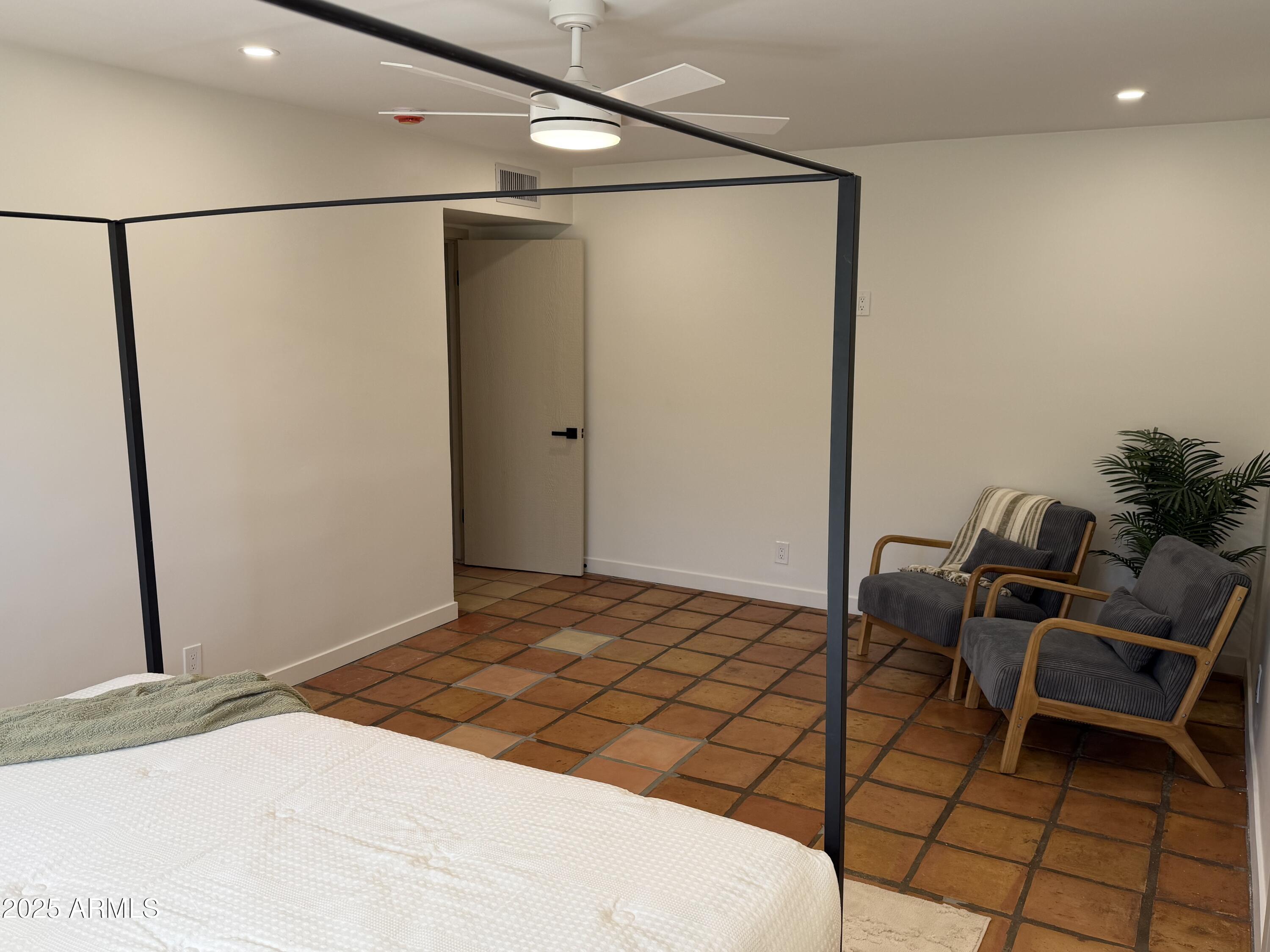 537 North Jay Street Chandler, AZ 85225 - Photo 16 of 39 a bedroom with a bed and a chair