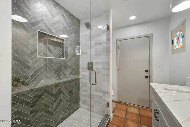 a bathroom with a sink vanity granite and a mirror