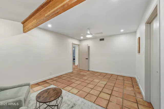 a workspace with furniture wall paintings and a window