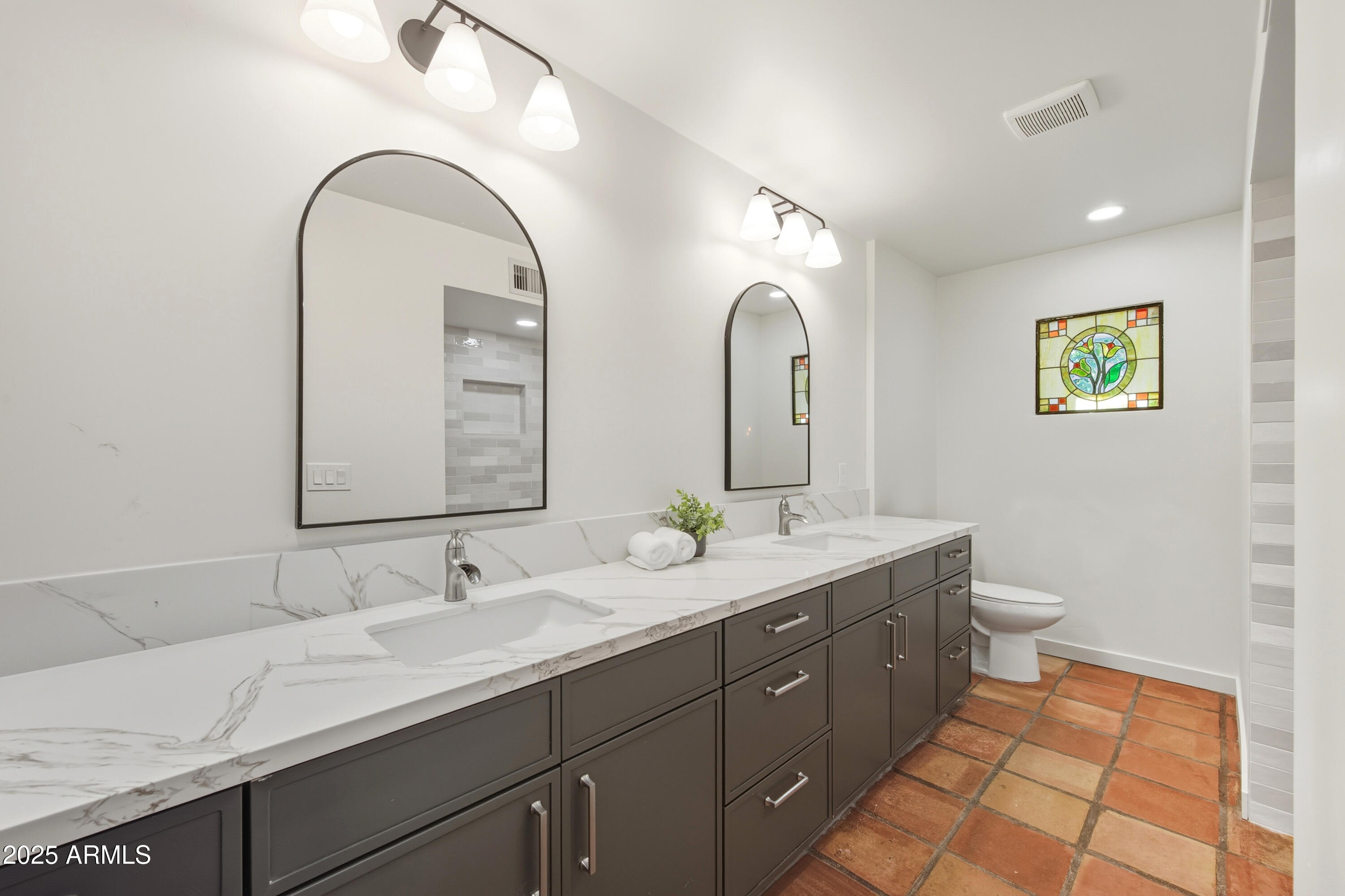 537 North Jay Street Chandler, AZ 85225 - Photo 25 of 39 a spacious bathroom with a granite countertop sink a toilet and a mirror
