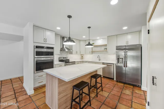 a picture of a bathroom with a white wall