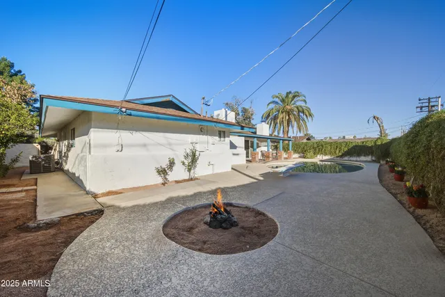a patio with patio area table and chairs