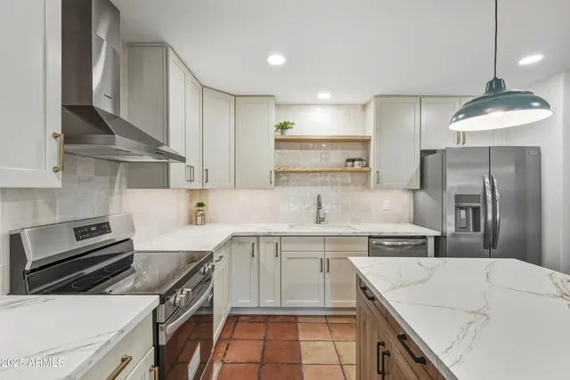 a kitchen with kitchen island a counter space appliances and cabinets