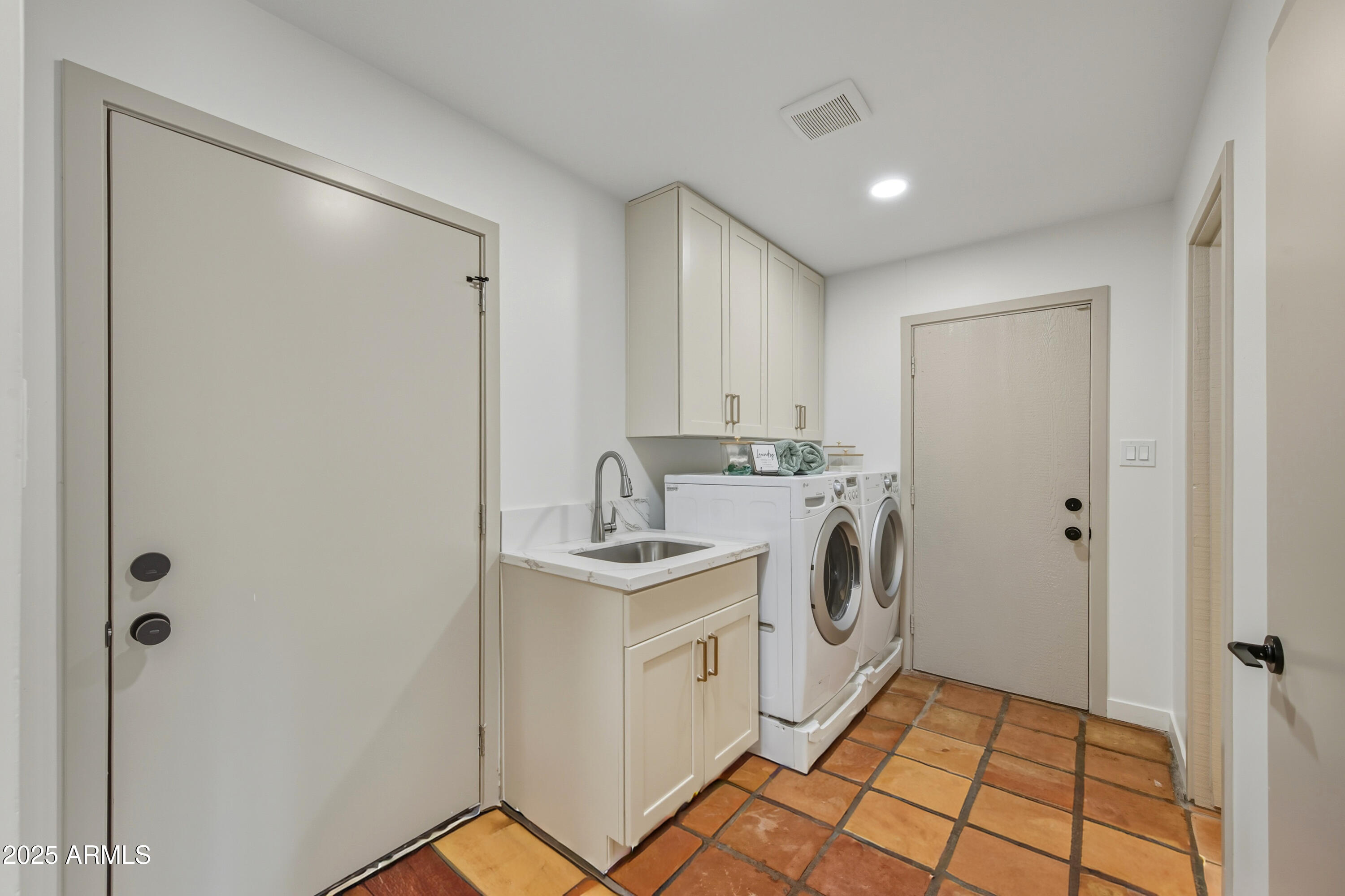 537 North Jay Street Chandler, AZ 85225 - Photo 4 of 39 a utility room with cabinets washer and dryer