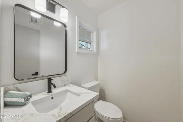a utility room with cabinets washer and dryer