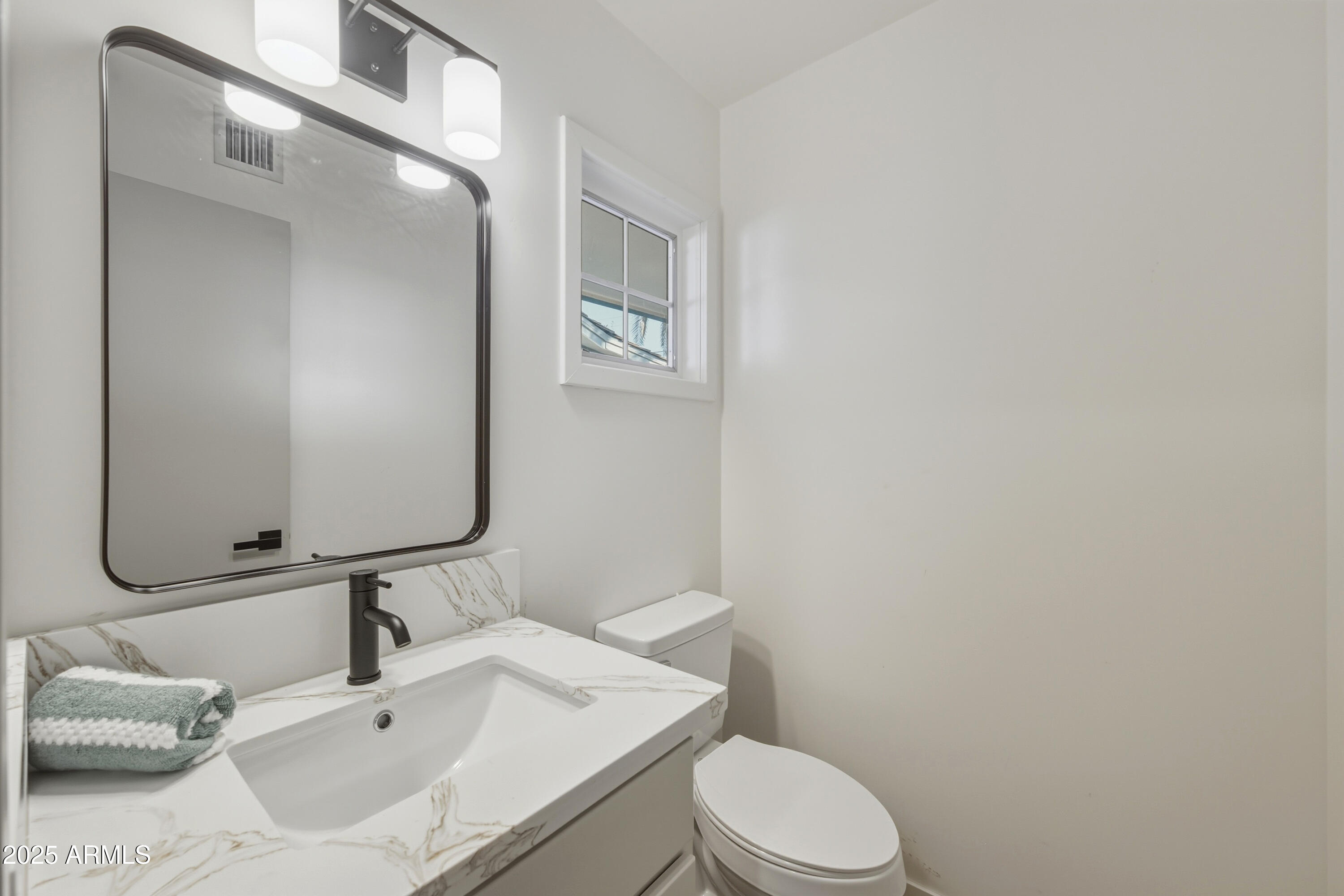 537 North Jay Street Chandler, AZ 85225 - Photo 5 of 39 a bathroom with a sink vanity mirror and toilet